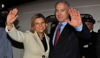 ** FILE ** In this photo released by the Israeli Government Press Office, Israeli Prime Minister Benjamin Netanyahu, right, and his wife Sara wave as they board a plane at Ben Gurion airport near Tel Aviv early Sunday, May 17, 2009, on their way for the first visit to Washington since Netanyahu became Israeli Prime Minister. 