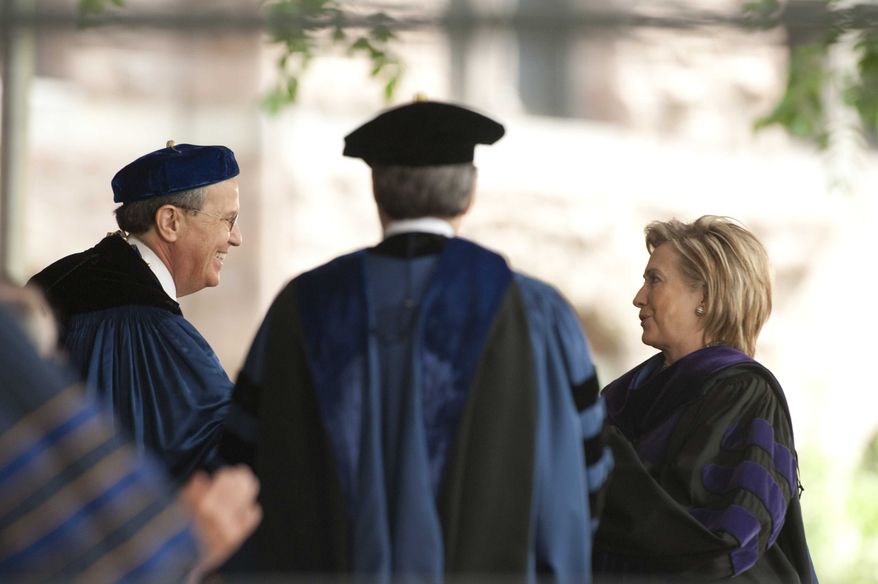 Secretary of State Hillary Rodham Clinton receives an honorary Doctor of Laws degree from Provost Peter Salovey center, and University President Richard Levin, left, at the Yale University commencement in New Haven, Conn. Monday, May 25, 2009. Clinton is a Yale Law School graduate and met Bill Clinton there in 1970. 
