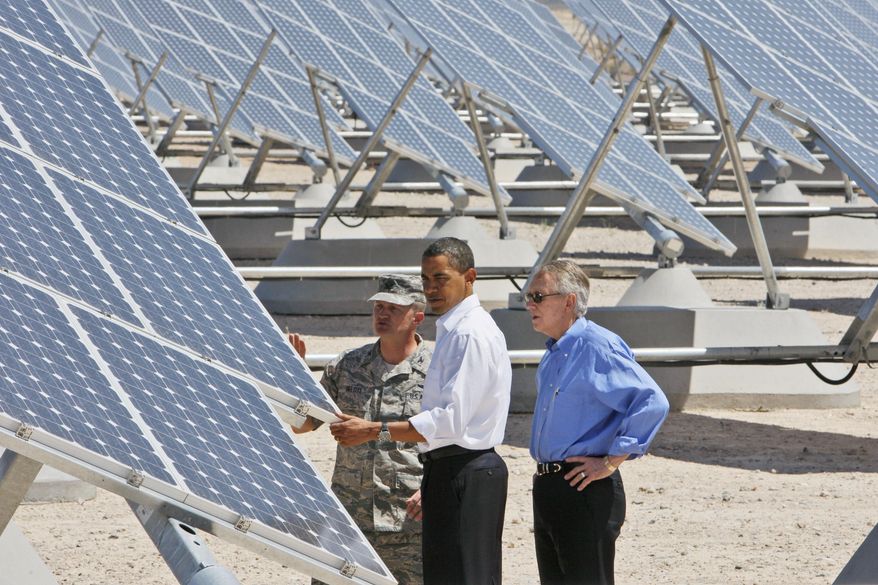 President Obama, accompanied by Senate Majority Leader Harry Reid (right), Nevada Democrat, and Col. Howard Belote, looks at solar panels at Nellis Air Force Base in Nevada on Wednesday, May 27, 2009. (AP Photo/Charles Dharapak)