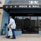 In this Aug. 17, 2006, file photo, Glen Brown, 65, from D.C., passes by the Rock &amp; Roll Hotel, a formal funeral home that was transformed into a bar and concert venue as part of a redevelopment of H street. (Nancy Pastor/The Washington Times )