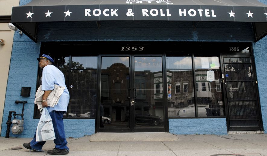 In this Aug. 17, 2006, file photo, Glen Brown, 65, from D.C., passes by the Rock &amp; Roll Hotel, a formal funeral home that was transformed into a bar and concert venue as part of a redevelopment of H street. (Nancy Pastor/The Washington Times )