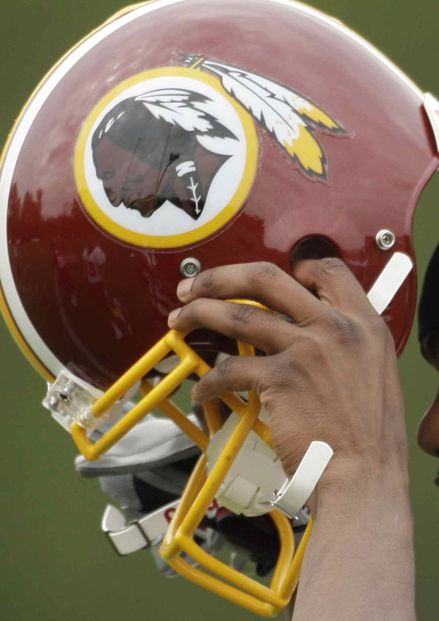 ** FILE ** In this May 1, 2009, file photo, Washington Redskins Marko Mitchell puts his helmet on during their NFL football minicamp practice at their training facility in Ashburn, Va. The Washington Redskins won another legal victory Friday, May 15, 2009, in a 17-year fight with a group of American Indians who argue the football team's trademark is racially offensive. The decision issued Friday by the U.S. Court of Appeals in Washington doesn't address the main question of racism at the center of the case. Instead, it upholds the lower court's decision in favor of the football team on a legal technicality. (AP Photo/Alex Brandon, File)