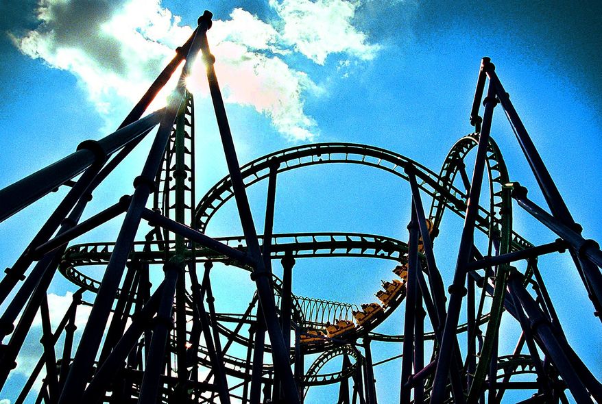 ** FILE ** People ride on the Joker's Jinx roller coaster at the Six Flags America Amusement Park in Largo, Md., in July 2002.