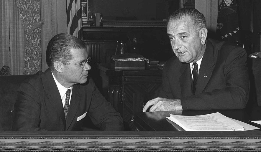 President Lyndon B. Johnson (right) confers with his secretary of defense, Robert McNamara. (AP Photo/ File)