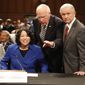 Supreme Court nominee Judge Sonia Sotomayor, accompanied by Senate Judiciary Committee Chairman Sen. Patrick Leahy, D-Vt., center, and the committee&#39;s ranking Republican Sen. Jeff Sessions, R-Ala., prepares to testify before the committee, Monday, July 13, 2009, on Capitol Hill in Washington. (AP Photo/Ron Edmonds)