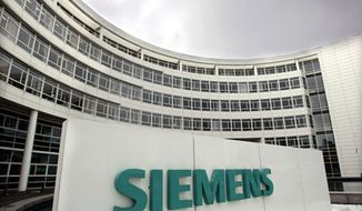 ** FILE ** Dark clouds hang above the Siemens headquarters in Munich in December 2006. (AP Photo/Diether Endlicher, File)