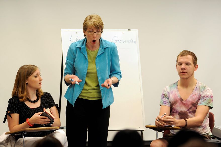 ASSOCIATED PRESS PHOTOGRAPHS
ABOVE: Mallory Taul (center) teaches a "mock" class with students Paula Carter and Zackary Ruesler last month during a "difficult dialogues" summer workshop for campus leaders hosted by the University of Missouri at Columbia. RIGHT: Suzanne Burgoyne simulates an unpleasant classroom encounter between an evolution-denying student and an astronomy professor struggling to control her lecture.
