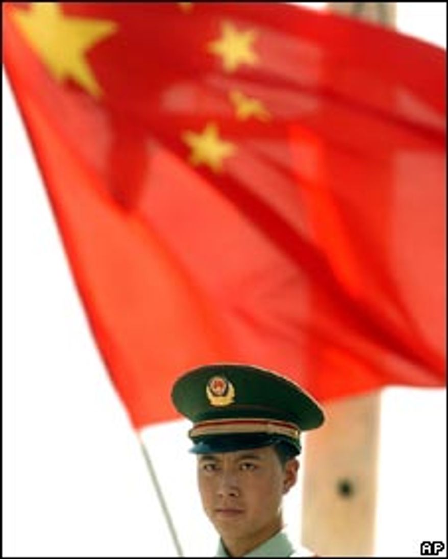 **FILE** A man carries a Chinese flag. (Associated Press)