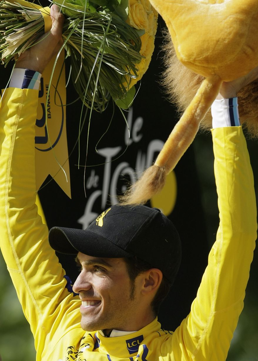 Tour de France winner Alberto Contador of Spain, wearing the overall leader's yellow jersey, celebrates after winning the cycling race for the second time. (AP Photo/Laurent Rebours)