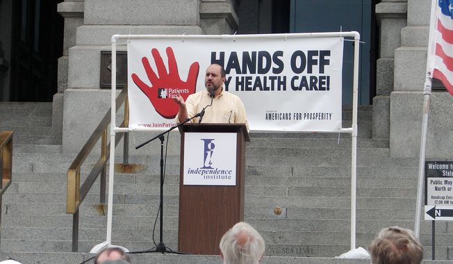 In this file photo, Jon Caldara, president of the Independence Institute, fires up the crowd at Colorado&#x27;s Capitol in Denver during a 2009 rally condemning then-President Barack Obama&#x27;s proposed health care plan. Mr. Caldara was recently let go from the Denver Post, where he had a regular opinion column. He says the liberal editor who terminated him did so because of his views on transgender rights issues being &quot;insensitive.&quot; (Valerie Richardson/The Washington Times) ** FILE **