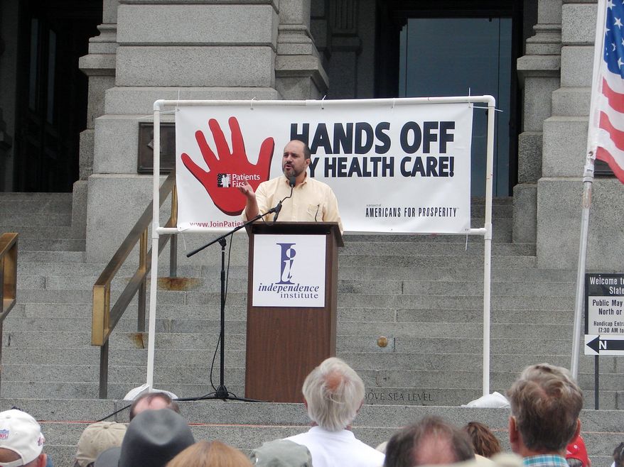 In this file photo, Jon Caldara, president of the Independence Institute, fires up the crowd at Colorado&#39;s Capitol in Denver during a 2009 rally condemning then-President Barack Obama&#39;s proposed health care plan. Mr. Caldara was recently let go from the Denver Post, where he had a regular opinion column. He says the liberal editor who terminated him did so because of his views on transgender rights issues being &quot;insensitive.&quot; (Valerie Richardson/The Washington Times) ** FILE **
