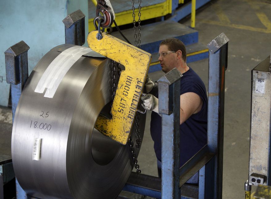 ** FILE ** Derek Jenkins, an employee at Baldor Electric Co., moves a large roll of steel inside the company's factory in St. Louis in June 2009. (AP Photo/Jeff Roberson, File)