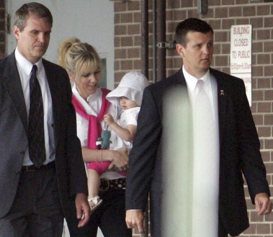 ** FILE ** Rielle Hunter (center) is escorted into the Terry Sanford Federal Building and Courthouse in Raleigh, N.C., on Thursday, Aug. 6, 2009. (AP Photo/Jim R. Bounds)