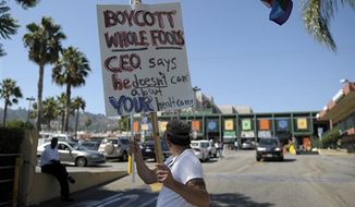 **FILE** Rick Watts, 49, protests outside a Whole Foods store in West Hollywood, Calif., on Aug. 23, 2009. The protest took place after John Mackey, the CEO of Whole Foods Market, wrote an op-ed piece for the Wall Street Journal about health care reform. (Associated Press)