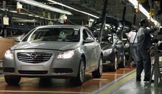 Workers are pictured on the assembly line of Opel&#39;s Insignia model at the company&#39;s plant in Ruesselsheim, Germany, in 2008. General Motors announced on Thursday, Dec. 5, 2013, that it will end shipments of Chevrolet cars to the Continent to focus on the German-based Opel and U.K.-based Vauxhall, its main brands in Europe. (AP Photo/Daniel Roland)
