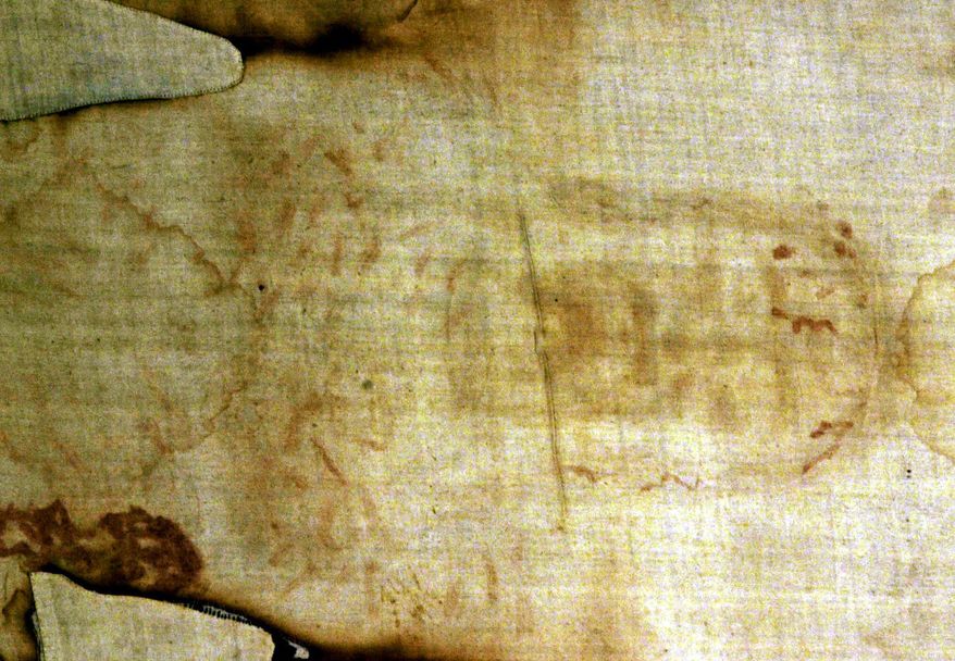 ** FILE ** The Shroud of Turin, a 14-foot-long linen revered by some as the burial cloth of Jesus, is shown at the cathedral in Turin, Italy, in 2000. (Associated Press)