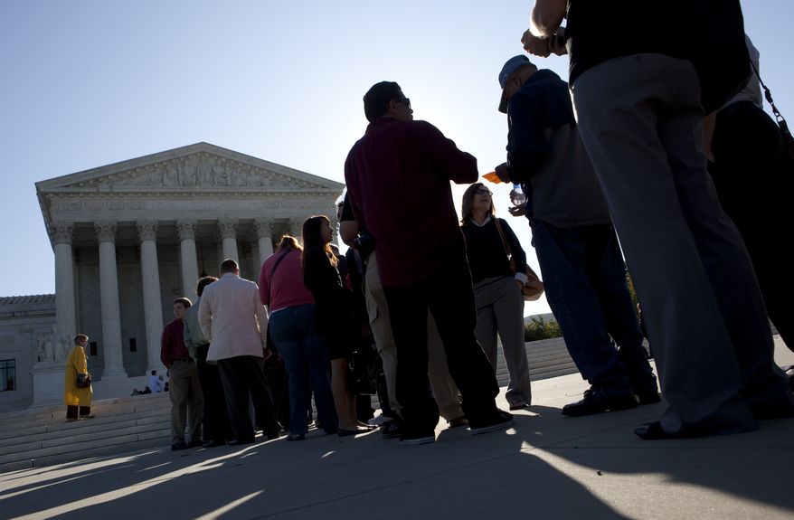 People wait in line outside the Supreme Court in Washington, Monday, Oct. 5, 2009, for the start of a court's new session, with the addition of the first Hispanic justice Sonia Sotomayor. (AP Photo/Evan Vucci)