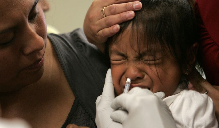 Amparo Martinez, left, watches as her daughter, Sorayo Martinez, 4, is given a dose of swine flu vaccine in Oregon City, Ore., Tuesday, Oct. 6, 2009. Children and health workers are the first to receive vaccines from the first batch to hit Oregon. (AP Photo/Don Ryan)