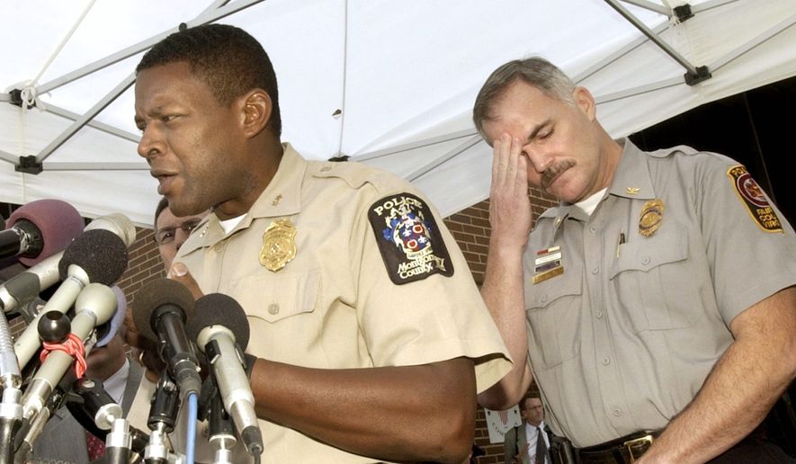Montgomery County Police Chief Charles Moose and then Fairfax County Police Chief Tom Manger discuss the case during a press conference at Montgomery County Police Headquarters in Rockville on Oct. 17, 2002. (J.M. Eddins Jr./The Washington Times)