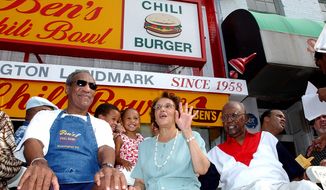 In this file photo from Aug. 22, 2003, comedian Bill Cosby (left) joins Ben Ali (right) and Ali&#39;s wife Virginia during a celebration on the 45th anniversary of Ben&#39;s Chili Bowl Restaurant in Washington. Ben Ali, founder of the restaurant which became a Washington landmark, died Wednesday at his home in Washington. He was 82. (Associated Press)