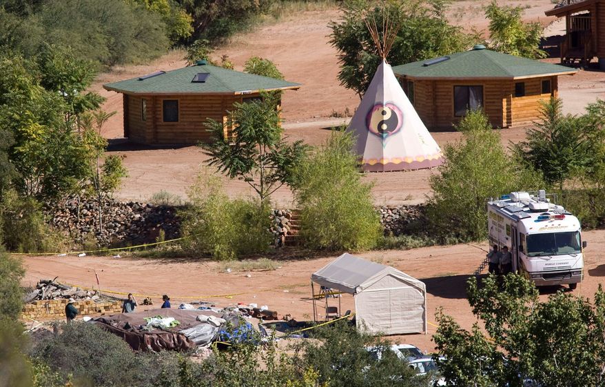 ** FILE ** Investigators examine a sweat lodge at the Angel Valley Retreat Center near Sedona, Ariz., where two people died in October 2009 after being overcome during a spiritual retreat. (AP Photo)