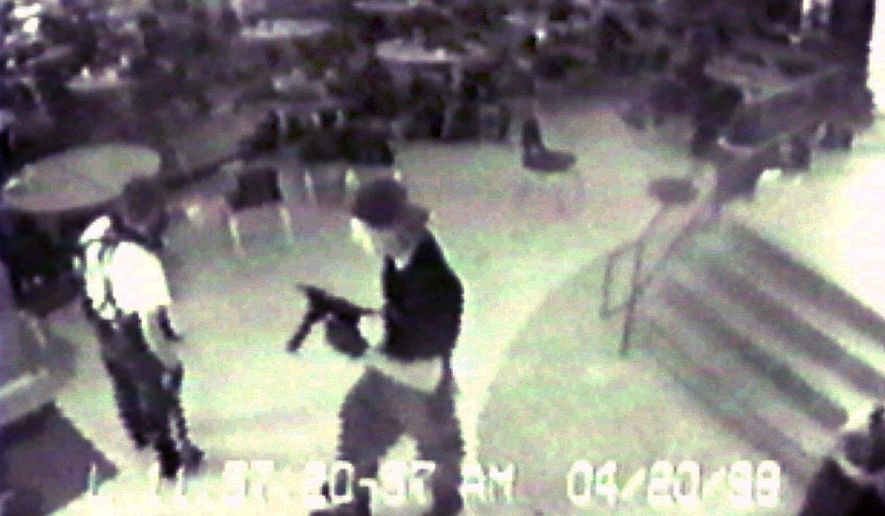 Eric Harris (left) and Dylan Klebold are seen from a security camera image at Columbine High School in Littleton, Colo., on April 20, 1999, during their shooting rampage. (Associated Press)