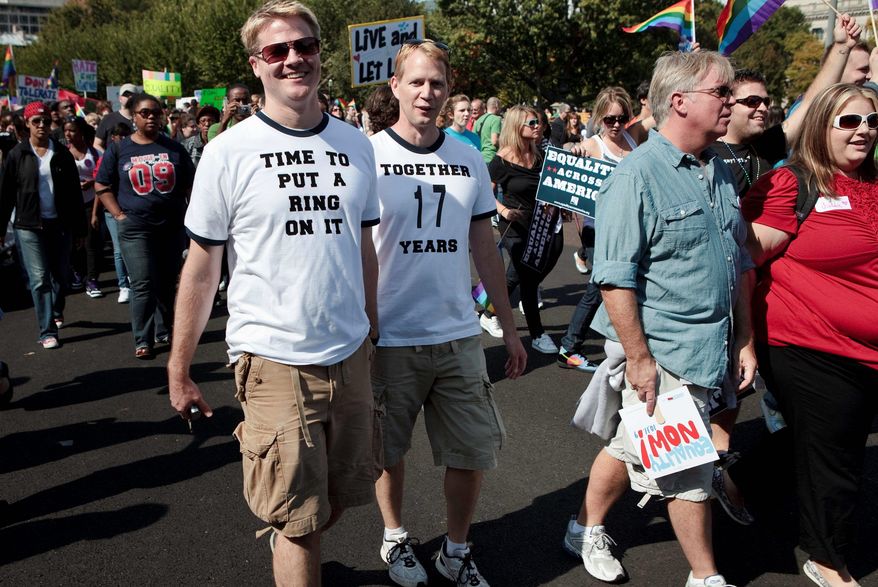 GETTY IMAGES
Gay rights activists march in a parade Sunday in Washington. Across the country, in California on Sunday, Gov. Arnold Schwarzenegger signed a bill recognizing as "domestic partnerships" tens of thousands of same-sex marriages.