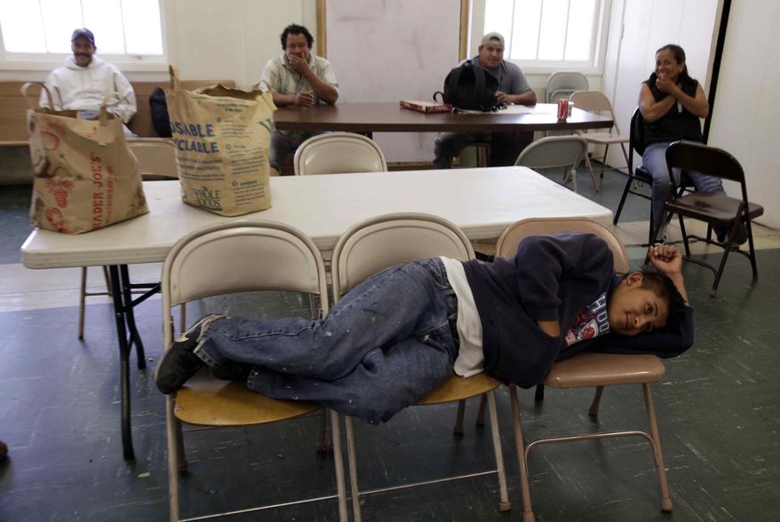 Unemployed worker Jesus Hernandez, who has been unemployed for over a month, waits with other unemployed people at the Day Worker Center of Mountain View, in Mountain View, Calif., on Friday, Oct. 2, 2009. (AP Photo/Paul Sakuma)