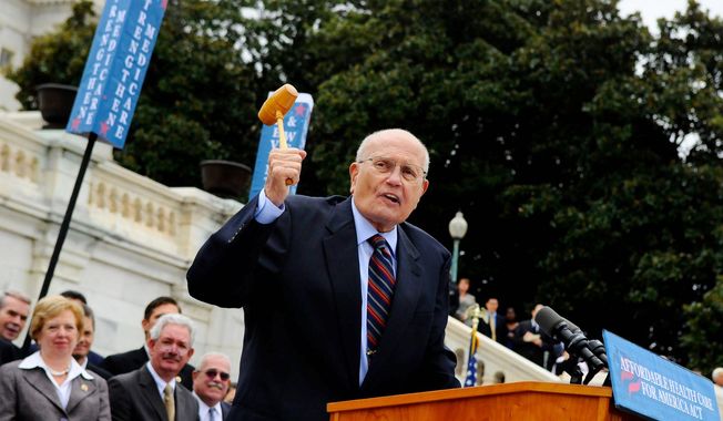 ** FILE ** Rep. John Dingell (D-MI) wields his old gavel as he talks about the issue of health care, during a press conference regarding H-232, the Affordable Health Care Act, on the west steps of the Capitol in Washington, D.C., Thursday, Oct. 29, 2009. (Rod Lamkey Jr./The Washington Times)