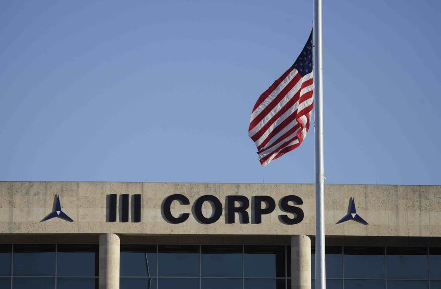 The U.S. flag flies at half staff in front of the Army's III Corps headquarters at Fort Hood, Texas, on Friday, Nov. 6, 2009. (AP Photo/LM Otero)