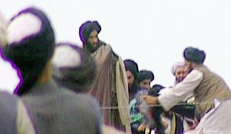 Five-year-old footage of Mullah Mohammed Omar (center) rallying his Taliban troops in Kandahar, Afghanistan, was found in the BBC&#39;s vaults and aired in 2009. (Associated Press/BBC TV) ** FILE **