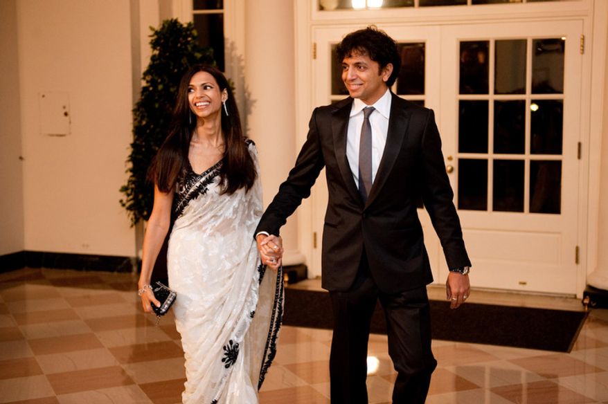 ** FILE ** M. Night Shyamalan and his wife Bhavna Shyamalan arrive for the State Dinner in honor of the Prime Minister of India at the White House in Washington, D.C., Tuesday, Nov. 24, 2009. (Michael Connor/The Washington Times)