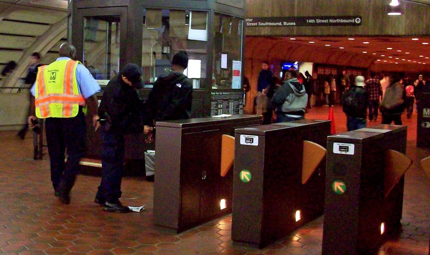 ** FILE ** Metro transit police arrest a suspect at the Columbia Heights Metro station in Washington. (John Muller/Special to The Washington Times)