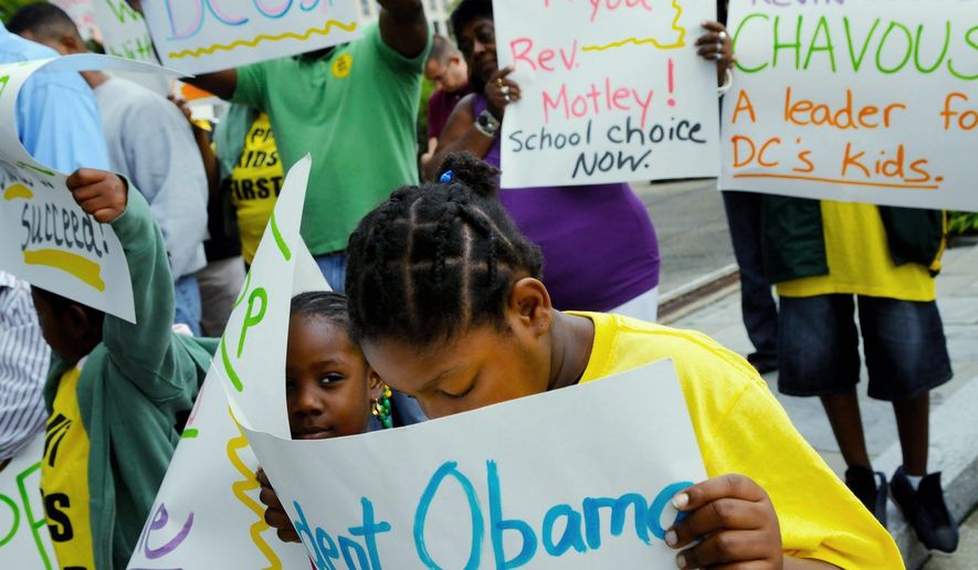 Shanice Ambrose (right), 10, and Melkaha Farmer, 5, hold their signs as they join former D.C. Council member and Chair of the Council&#39;s Education Committee Kevin Chavous as he leads a short rally and an attempt at public disobedience by trying to get himself and five others arrested for blocking the entrance to the U.S. Department of Education in D.C. on Sept. 8, 2009, to protest the elimination of the DC school voucher program. (Rod Lamkey Jr./The Washington Times) **FILE**