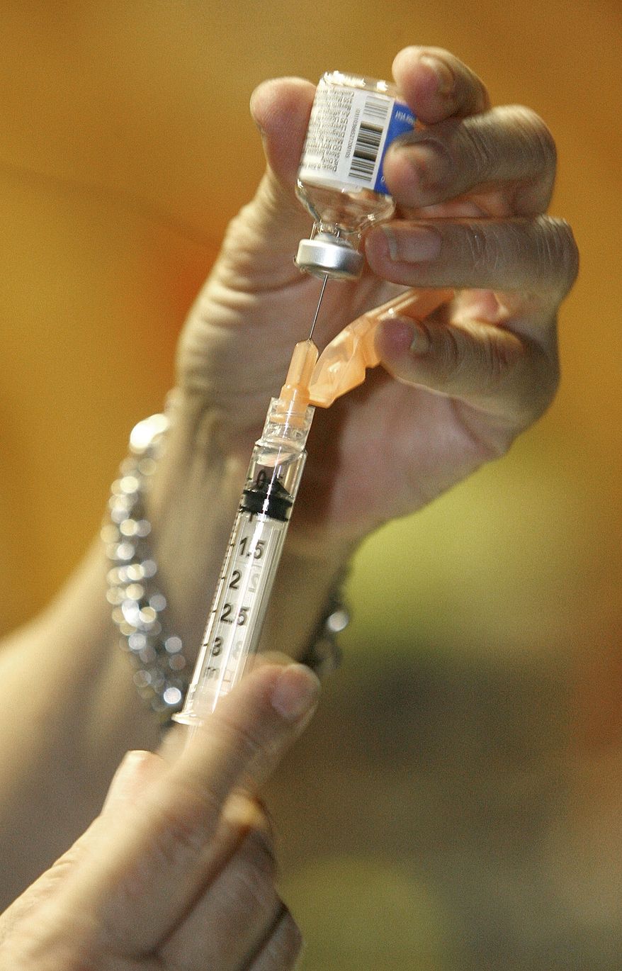 Nurse Margaret England of the Central Vermont Home Health and Hospice draws some H1N1 vaccine during a swine flu clinic in Montpelier, Vt., Monday, Nov. 23, 2009. (AP Photo/Toby Talbot)