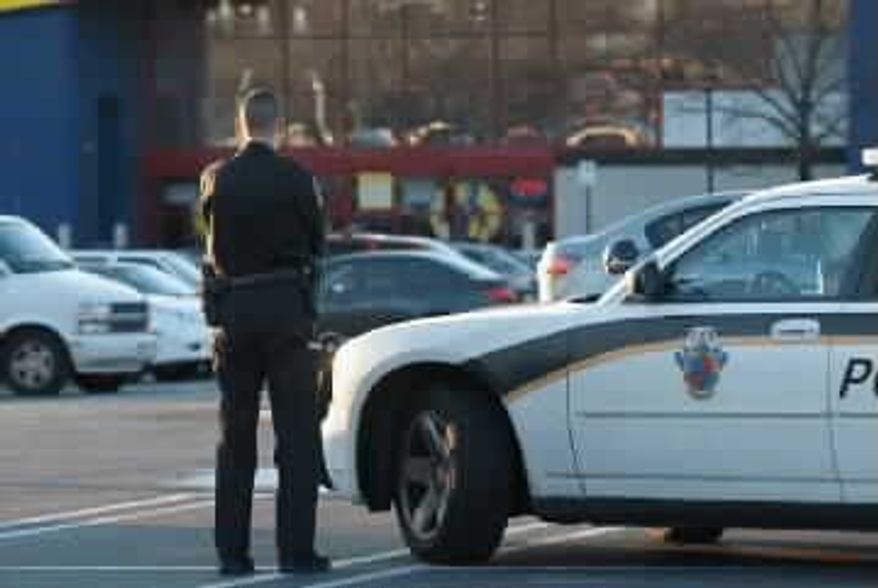 ** FILE ** A police officer patrols a parking lot in Montgomery County. (Photo provided by the Montgomery County Police Department)