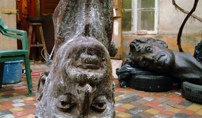 This undated file photo provided by Saulius Paukstys shows a cast used to create a replica of a bust of musician Frank Zappa in an art studio in Vilnius, Lithuania. The original bust, which sits in a public square in Vilnius, can be seen in the background. (Associated Press)