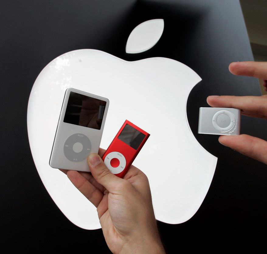 Apple's 60GB iPod (left) is shown next to an iPod Nano (center) and then-new iPod Shuffle at an Apple store in November 2006.
