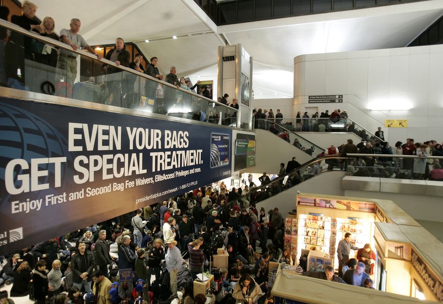 ** FILE ** Passengers fill the terminal after a security breach shut down Terminal C at Newark Liberty International Airport in Newark, N.J., on Sunday, Jan. 3, 2010. Authorities were searching for a man who walked through a screening checkpoint exit into the secure side of a terminal Sunday night. Flights were grounded and passengers were rescreened, an air safety official said. (AP Photo/Rich Schultz)