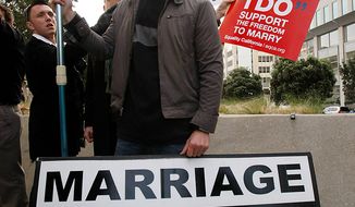 Luke Otterstad carries a sign about traditional marriage as demonstrators protest around him during a rally in front of a federal courthouse in San Francisco, Monday, Jan. 11, 2010. (AP Photo/Paul Sakuma)