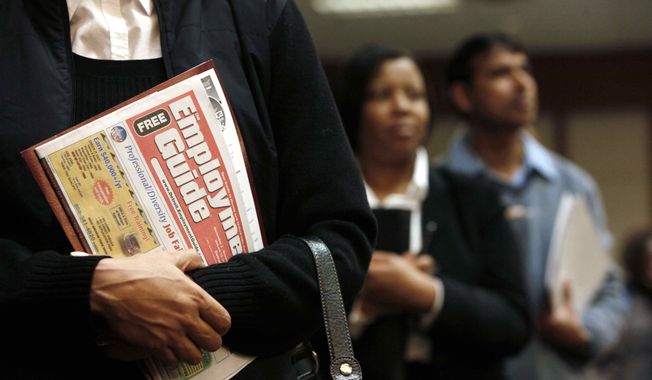 In this Nov. 4, 2009 file photo, a Detroit woman holds a Employment Guide standing in line while attending a job fair in Livonia, Mich. (AP Photo/Paul Sancya, File) **FILE**