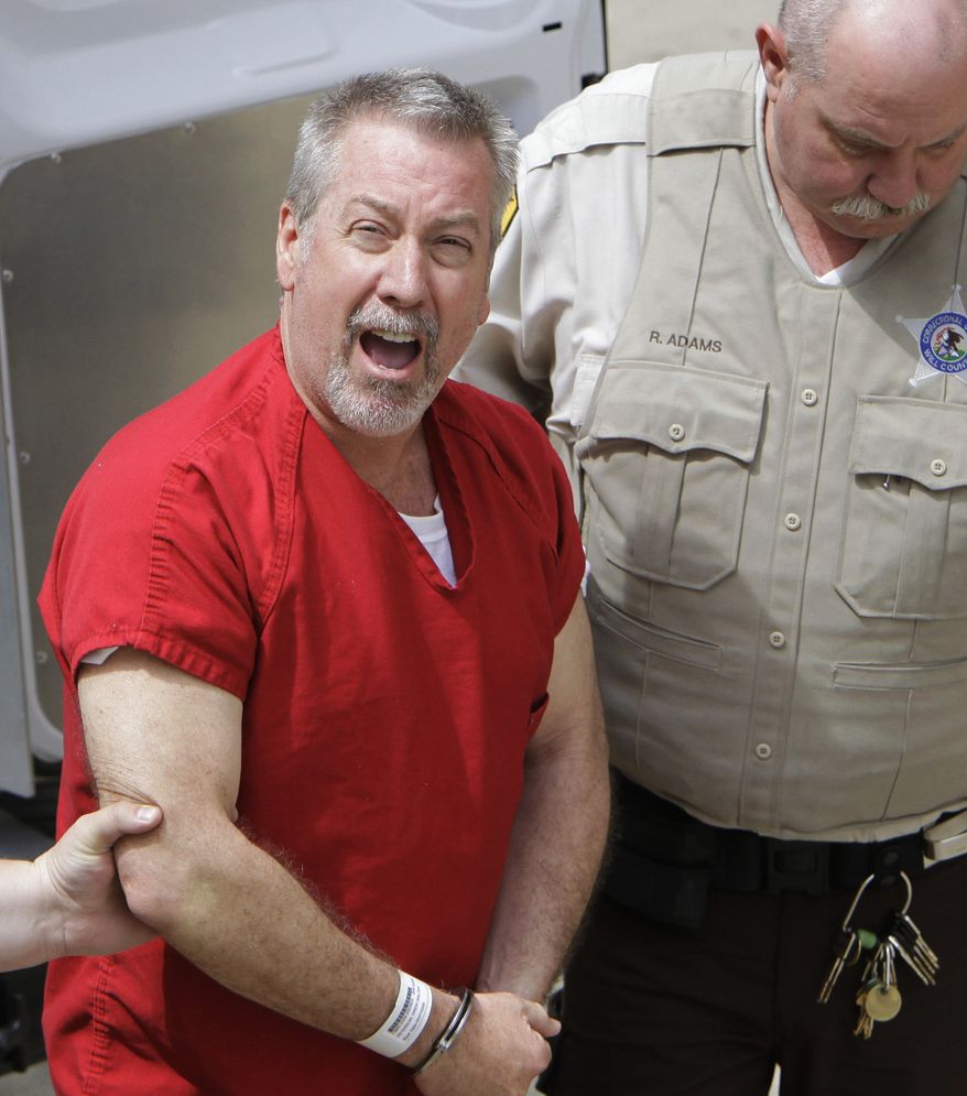 **FILE** In this May 8, 2009 photo, former Bolingbrook, Ill., police sergeant Drew Peterson yells to reporters as he arrives at the Will County Courthouse in Joliet, Ill. (Associated Press)
