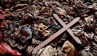 A wooden cross lies in Nyamata, Rwanda. (Associated Press)