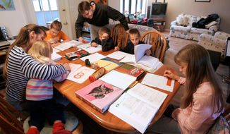 Uwe Romeike and his wife, Hannelore, worked with their children at home in Morristown, Tenn., last year. The German family was granted political asylum in the U.S. on grounds they faced persecution in Germany for home schooling. (Associated Press)