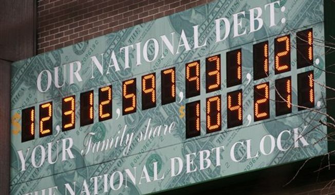 In this file photo, The National Debt Clock, a privately funded estimate of the national debt, is shown on Feb. 1, 2010, in New York. (Associated Press) **FILE**