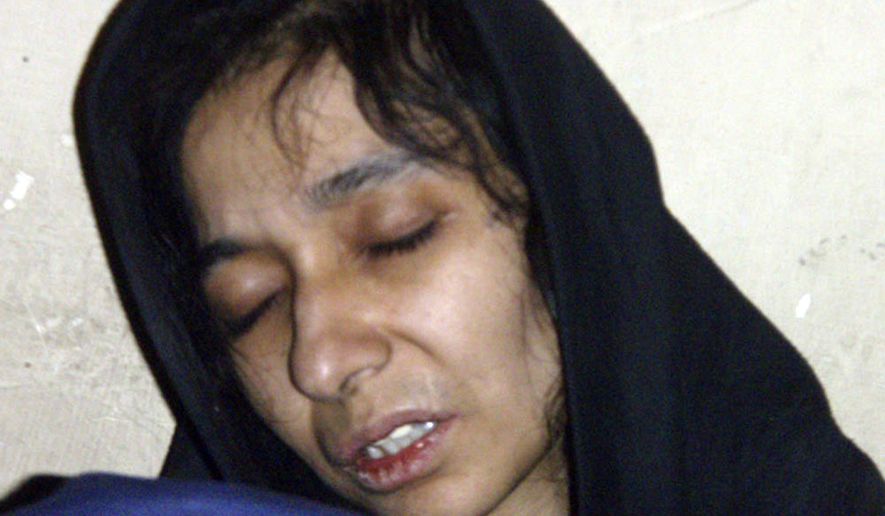 ** FILE ** Aafia Siddiqui is seen in the custody of the Counter Terrorism Department of Ghazni province in Ghazni City, Afghanistan, on July 17, 2008. The U.S.-trained Pakistani scientist was convicted by a jury on Wednesday, Feb. 3, 2010, of charges she tried to kill Americans while she was detained in Afghanistan. (AP Photo/File)