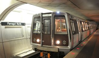 ** FILE ** A Red Line train passes through the Farragut North Metro station in Washington. (Associated Press)