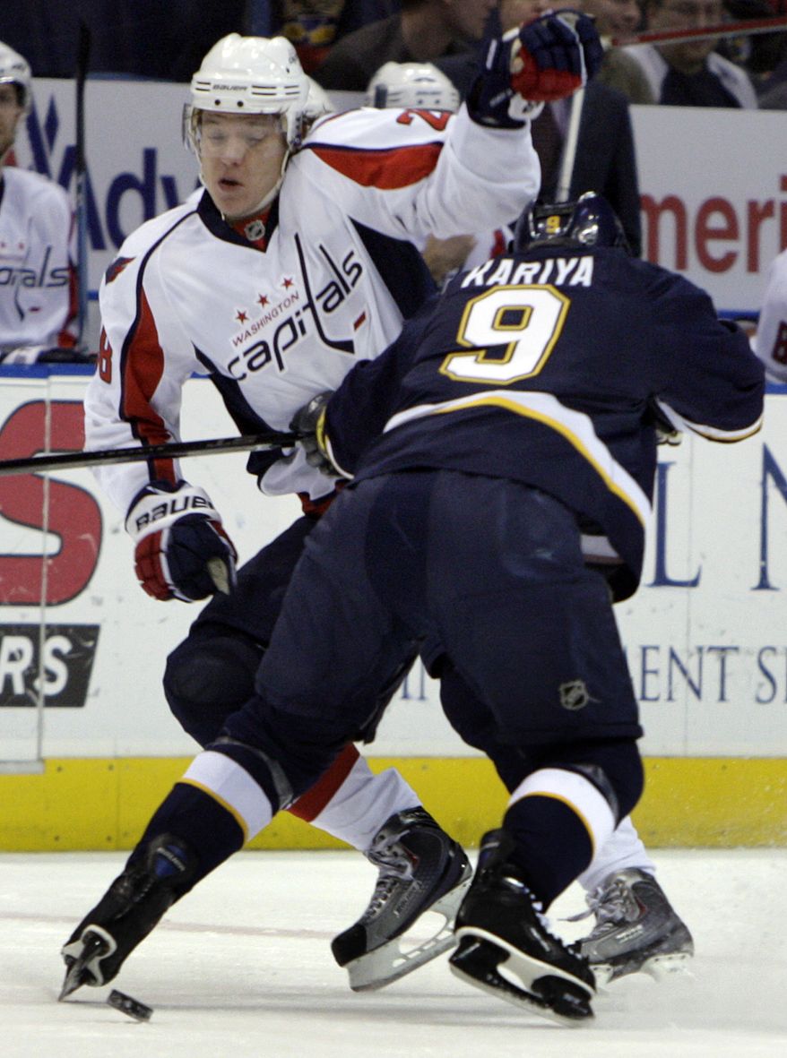 ASSOCIATED PRESS Washington Capitals' Alexander Semin, of Russia, tries to maneuver around St. Louis Blues' Paul Kariya (9) during the first period of an NHL hockey game Saturday, Feb. 13, 2010, in St. Louis.