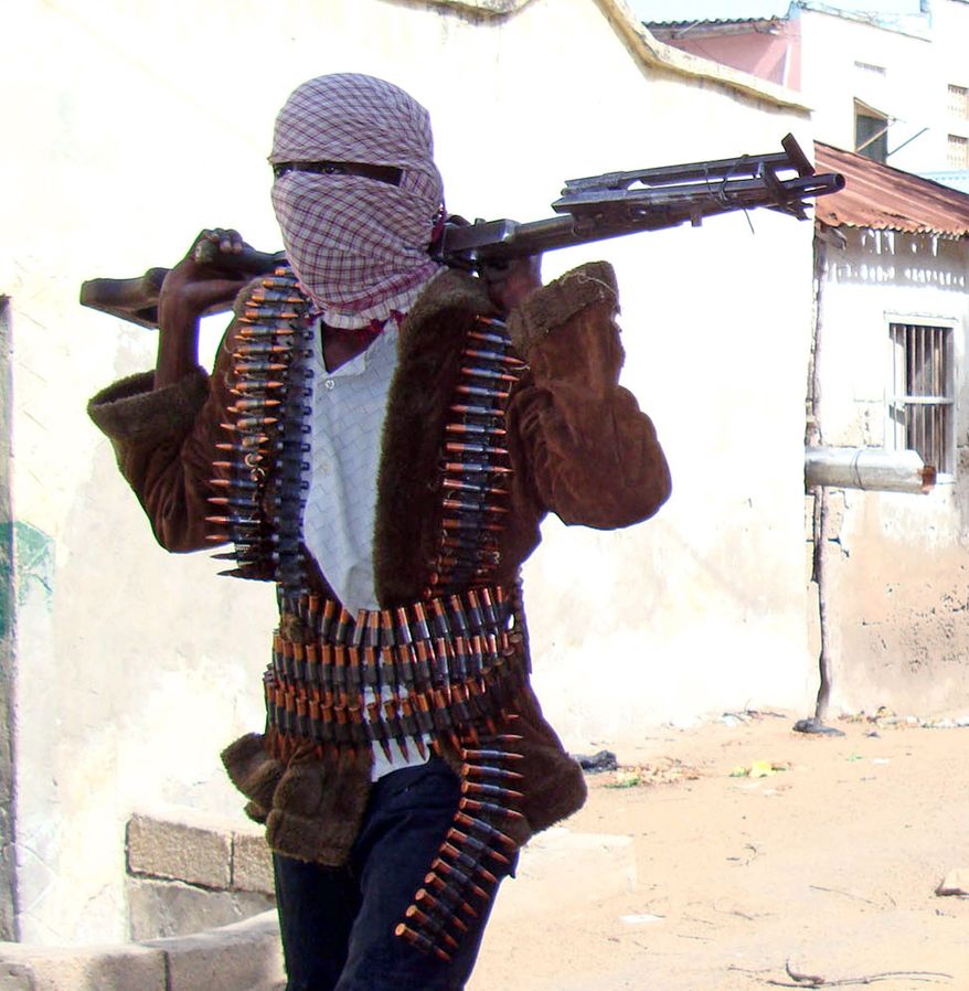 **FILE** A Somali Islamist militant patrols the streets of Mogadishu. Al-Shabab Islamic insurgents, with links to al Qaeda, last year looted two United Nations compounds in southern Somalia. The Somali capital sees almost daily attacks aimed at disrupting the weak government. (Associated Press)