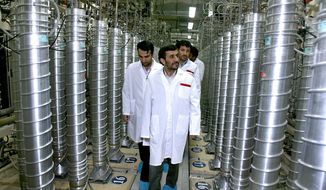 ** FILE ** Iranian President Mahmoud Ahmadinejad (center) visits the Natanz uranium enrichment facility, about 200 miles from the capital of Tehran, in April 2008. (AP Photo/Iranian President&#39;s Office)
